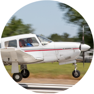 A student pilot practicing a spot landing in an aircraft.